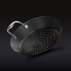 The underside of the HexClad 12&quot Hybrid BBQ Grill Pan on a black background